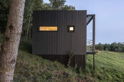 Миниатюрный домик для отдыха, построенный в лесу. Фото