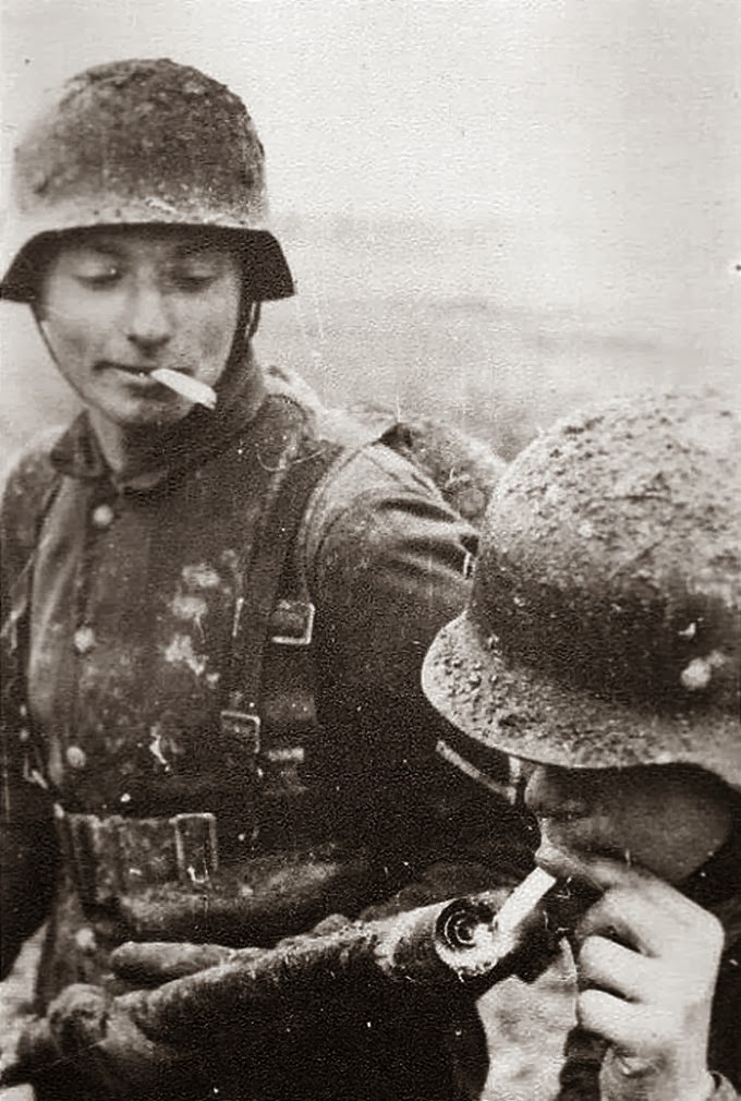 German soldier lights his cigarette with a flame thrower, 1940's